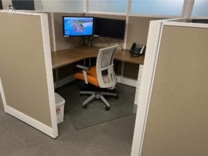 Cubicle with Desk Chair and dual monitors 