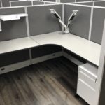 Cubicle with desk and monitor arm