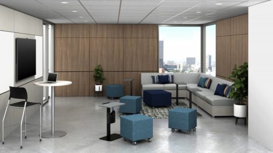 open office with couch, high top table, and stools